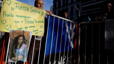 A man stands behind a fence where a banner reads in Spanish "Be Strong Cristina, recover soon because people need you more than ever" in support of Argentina's President Cristina Fernandez outside the Favaloro Hospital where she is undergoing surgery to her skull to siphon out blood that is pressuring her brain, months after she suffered an unexplained head injury in Buenos Aires, Argentina, Tuesday, Oct. 8, 2013. Fernandez was diagnosed with "chronic subdural hematoma," or fluid trapped between the skull and brain. (AP Photo/Natacha Pisarenko)