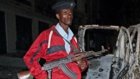 Un soldado vigila los restos del auto estacionado a las afueras del hotel Maka Al-mukarramah.