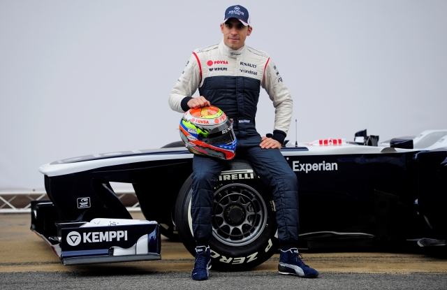 Williams Venezuelan driver Pastor Maldonado poses next to the new Williams FW35 Formula One racing car before a training session at the Montmelo racetrack near of Barcelona, Spain, Tuesday, Feb. 19, 2013. . (AP Photo/Manu Fernandez)