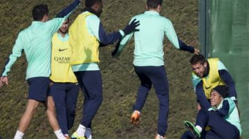 Neymar (izq.) es presa de una broma por parte de los jugadores del Barcelona en la práctica de ayer.