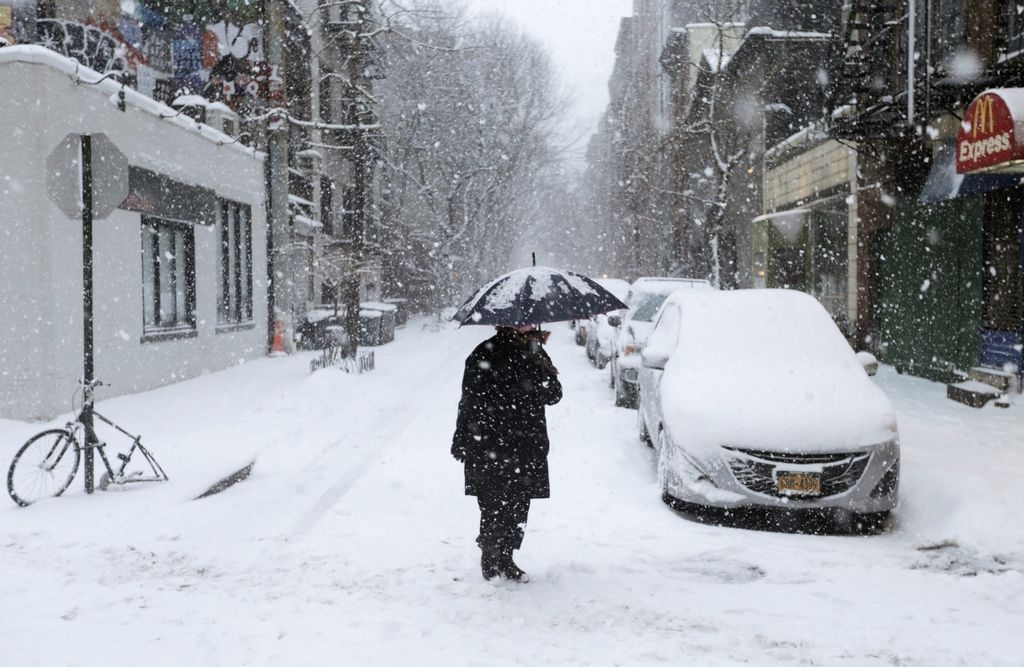 Una persona camina bajo la nieve en una calle de Nueva York.