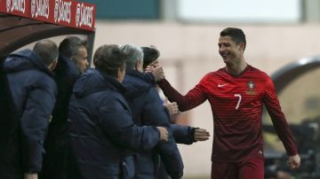 El artillero Cristiano Ronaldo (der.) es felicitado por el cuerpo técnico de Portugal  luego de ser relevado durante el juego  frente a Camerún.
