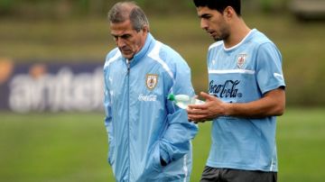 El técnico uruguayo Oscar Tabárez (izq.) conversa con el astro Luis Suárez.
