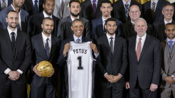 Obama posa con la camiseta entregada por los Spurs de San Antonio en la Casa Blanca.