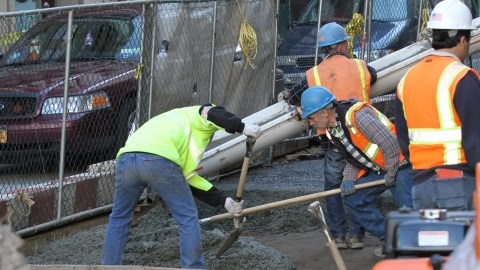 Construction workers fixing bridges and city streets in Manhattan.