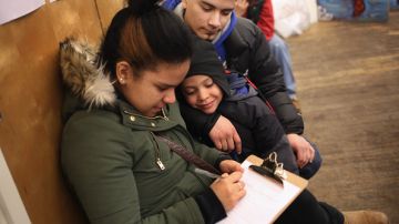 A family fills out an application for Deferred Action for Childhood Arrivals (DACA), at a workshop on February 18, 2015 in New York City.