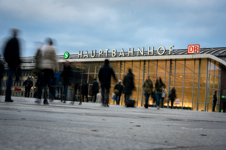 Pedestrians walk in front of Hauptbahnhof main railway station