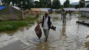 Nepalese earthquake victims collect belongings from a temporary shelter after the Hanumente River overflowed following monsoon rain in Bhaktapur on the outskirts of Kathmandu on August 27, 2015. Monsoon rains are slowing rebuilding and relief efforts after nearly 8,900 people died and some 600,000 homes were reduced to rubble across the impverished Himalayan nation following the deastating earthquake that struck Nepal on April 25. AFP PHOTO / Prakash MATHEMA (Photo credit should read PRAKASH MATHEMA/AFP/Getty Images)