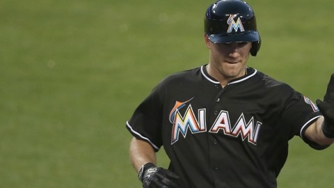 J.T. Realmuto de los Miami Marlins festeja un jonrón con su manager Don Mattingly y con Martin Prado.