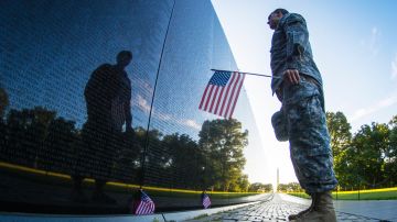 Soldier reflects and Vietnam Memorial wall