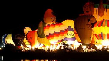 SAGA, JAPAN - NOVEMBER 03:  Hot Air Balloons are illuminated at the night mooring show 'La Montgorlfier Nocturne' during the Saga International Balloon Fiesta on November 3, 2009 in Saga, Japan. Over 100 hot air balloons from 15 countries and regions take part in what is one of the biggest ballooning events in Asia, attracting visitors and tourists from far and wide.  (Photo by Kiyoshi Ota/Getty Images)