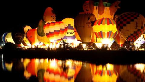 SAGA, JAPAN - NOVEMBER 03:  Hot Air Balloons are illuminated at the night mooring show 'La Montgorlfier Nocturne' during the Saga International Balloon Fiesta on November 3, 2009 in Saga, Japan. Over 100 hot air balloons from 15 countries and regions take part in what is one of the biggest ballooning events in Asia, attracting visitors and tourists from far and wide.  (Photo by Kiyoshi Ota/Getty Images)