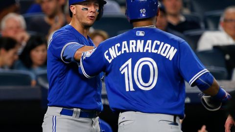 NEW YORK, NY - AUGUST 16: Troy Tulowitzki #2 congratulates Edwin Encarnacion #10 of the Toronto Blue Jays after he hit a two run home run during the sixth inning of a game against the New York Yankees at Yankee Stadium on August 16, 2016 in the Bronx borough of New York City. (Photo by Rich Schultz/Getty Images)