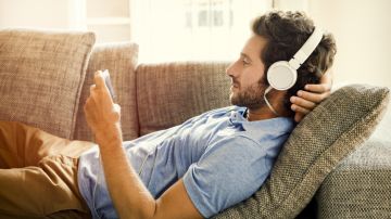 6_6-adult_health_i-see-you-are-awake-too_slideshow-6_man-relaxing-on-couch-listening-to-music-ts_493688136
