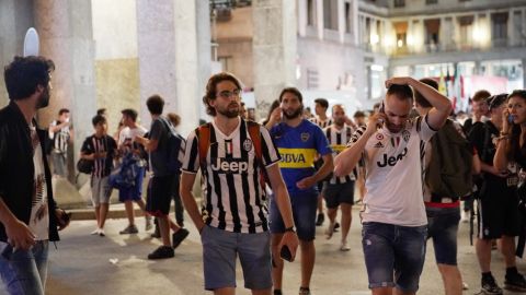 People flee San Carlos Square during a televised viewing of the Champions League Final after false reports of a bomb