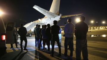 Un grupo de inmigrantes indocumentados espera abrodar un avión que los llevará de regreso a su país.