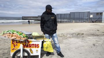 Un migrante de Haití vende elotes en las playas de Tijuana.