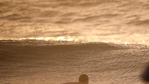 Un hombre surfea las olas en el Océano Atlántico en la playa Wrightsville en Carolina del Norte, estado que espera el azote de Florence.