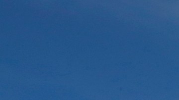 Cristina Bautista y Joaquina García posan con fotos de sus hijos, Benjamín Ascencio Bautista y Martín Getsemaní Sánchez García durante un plantón frente al Consulado de México en Los Ángeles.  (Aurelia Ventura/La Opinion)