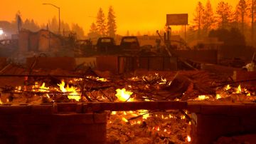 Un negocio arrasado por las llamas continuaba ardiendo un día después. Getty Images