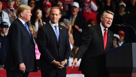 Trump (i) y Ted Budd (c) escuchan a Mark Harris (d) en un mitin en Carolina del Norte.