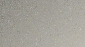 Un visitante pasa cerca de fotografías sobre metal instaladas en el Museo de Arte Contemporaneao (MOCA).