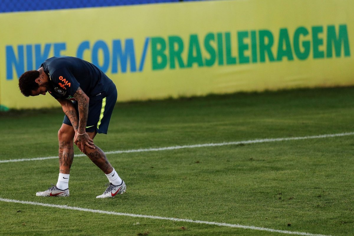 El futbolista brasileño Neymar toca su rodilla izquierda durante el entrenamiento de la selección brasileña. 