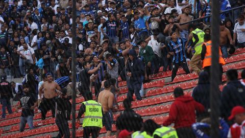 Los aficionados tuvieron que invadir la cancha para resguardarse de los golpes.