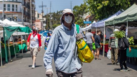 Shoppers walk at the West LA Farmer's Market in Santa Monica, California on May 3, 2020. - All Farmers Markets in the City of Los Angeles must have an approved COVID-19 operational plan to work under public health orders and Mayor Garcetti's direction. (Photo by Apu GOMES / AFP) (Photo by APU GOMES/AFP via Getty Images)