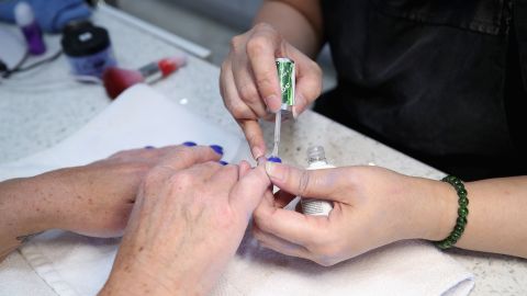 GLENDALE, ARIZONA - APRIL 03: A woman has her nails polished by a cosmetologist at Avalon Nails on April 03, 2020 in Glendale, Arizona. Arizona Gov. Doug Ducey expanded his statewide stay-at-home order to close hair and nail salons by Saturday April 04 at 5pm to combat the coronavirus (COVID-19) outbreak .