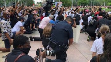 El jefe de la Policía de Houston Art Acevedo (centro) hincado en una de las manifestaciones.