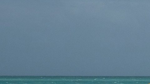 People enjoy the waves on the closed beach in Miami beach, Florida, USA, 01 August 2020. Hurricane Isaias weakened and lost intensity after passing over the Bahamas and it still on course to arrive off the coast of Florida Saturday night, according to the National Hurricane Center.