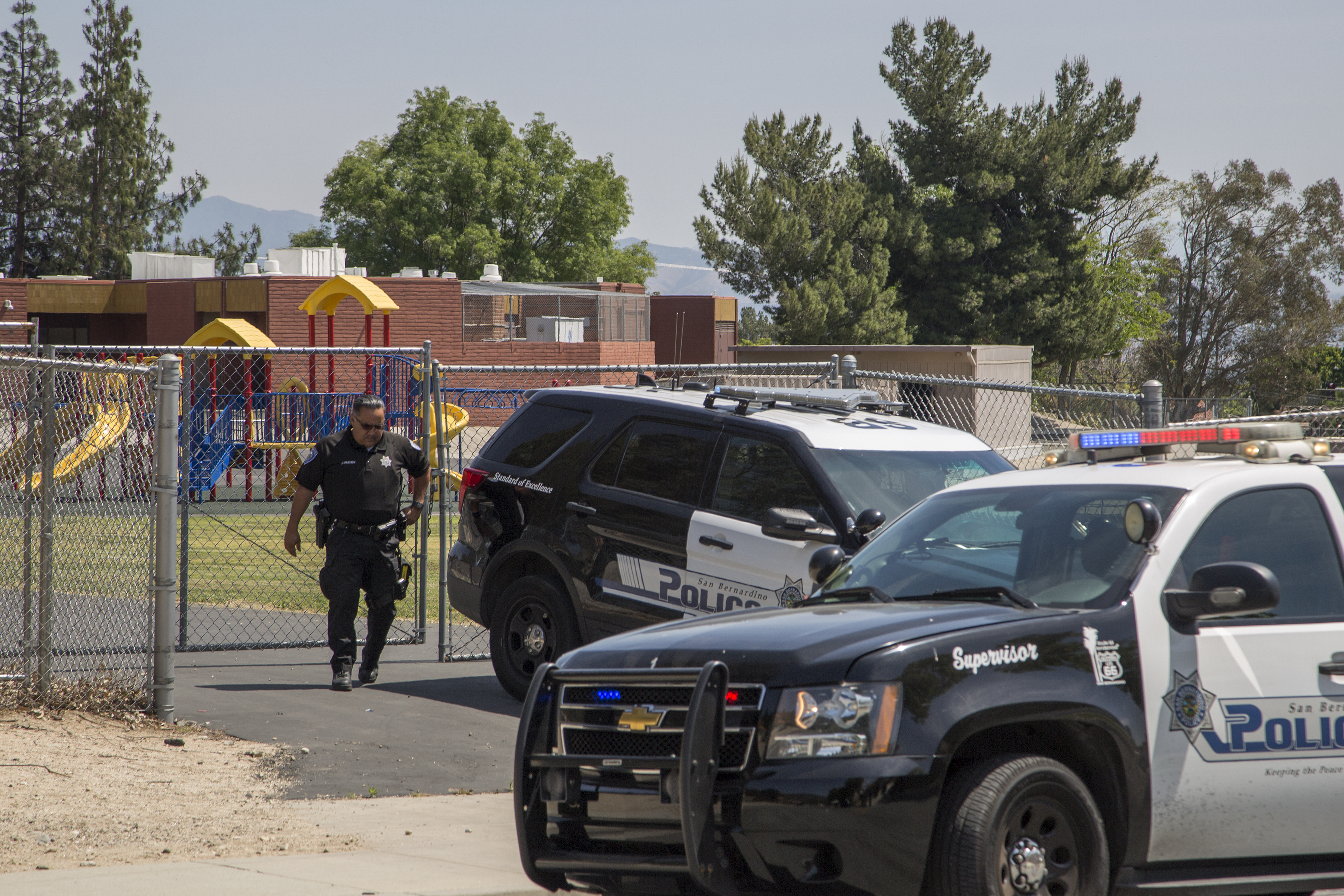 SAN BERNARDINO, CA - APRIL 10: Police officers stand guard at North Park Elementary School following a shooting on campus on April 10, 2017 in San Bernardino, California. Two people died, including the suspected shooter, and two children were wounded in the apparent murder-suicide attack. (Photo by David McNew/Getty Images)