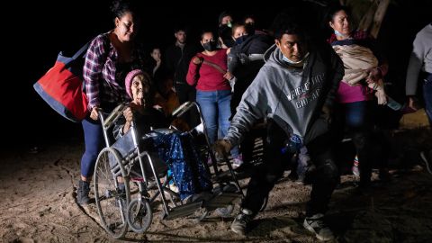 ROMA, TEXAS - APRIL 29: Honduran immigrant Trinidad Tabora, 93, is wheeled from the bank of the Rio Grande after crossing the border from Mexico on April 29, 2021 in Roma, Texas. She and her granddaughter (L) were smuggled across the border with other Central American asylum seekers during the early hours of the morning. A surge of mostly Central American immigrants crossing into the United States has challenged U.S. immigration agencies along the U.S. southern border. (Photo by John Moore/Getty Images)