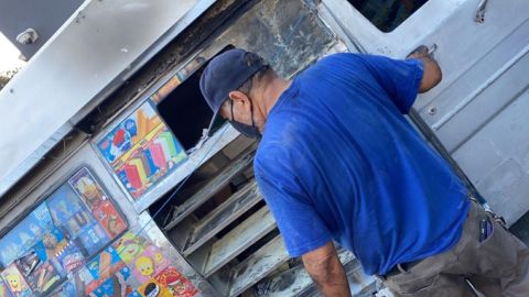 Hugo Dávila limpiando su camión de helados que fue quemado. (Suministrada)