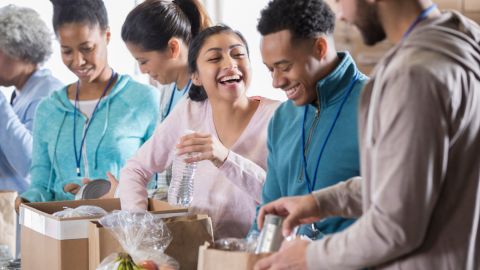 Happy couple volunteer in community food bank