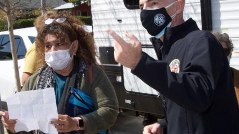 Una residente local recibe instrucciones del concejal Mitch O'Farrell en un centro vacacional.