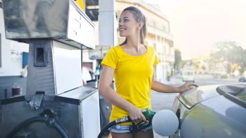 Foto de una mujer poniendo gasolina en su auto