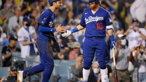 Trea Turner es felicitado por Justin Turner durante el juego que los Dodgers ganaron a los Mets.