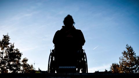 TOPSHOT - A man sits in his wheelchair on top of the stairs of a metro station in Paris on September 26, 2018 during a demonstration called by the Paralysed Association of France (APF) to demand more accessibility in their daily life and protest against the lack of accessibility for disabled and handicapped people in urban transports. (Photo by Philippe LOPEZ / AFP) (Photo credit should read PHILIPPE LOPEZ/AFP via Getty Images)