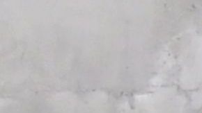 TOPSHOT - A man gestures while seated beside a Skid Row painting on a sidewalk in downtown Los Angeles on May 30, 2019. - The city of Los Angeles on May 29 agreed to allow homeless people on Skid Row to keep their property and not have it seized, providing the items are not bulky or hazardous. (Photo by Frederic J. BROWN / AFP) (Photo credit should read FREDERIC J. BROWN/AFP via Getty Images)