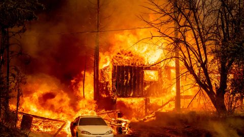 TOPSHOT - A home is engulfed in flames as the Dixie fire rages on in Greenville, California on August 5, 2021. - The largest wildfire in California has razed a small town, warping street lights and destroying historic buildings hours after residents were ordered to flee. Greenville, an Indian Valley settlement of a few hundred people dating back to the mid-1800s Gold Rush, was engulfed by flames as winds whipped the inferno towards the community, turning the sky orange. (Photo by JOSH EDELSON / AFP) (Photo by JOSH EDELSON/AFP via Getty Images)