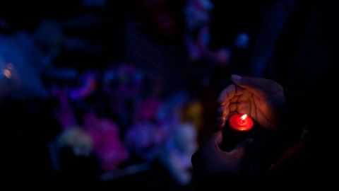 CHICAGO, IL - MARCH 12: A woman holds a candle during a vigil for slain infant Jonylah Watkins on March 12, 2013 in Chicago, Illinois. The 6-month-old girl was shot five times on the 6500 block of South Maryland Avenue while her father was changing her diaper in the passenger seat of his car. The father, Jonathan Watkins remains is stable condition at Nothwestern Memorial Hospital after receiving three gunshot wounds.(Photo by Jonathan Gibby/Getty Images)