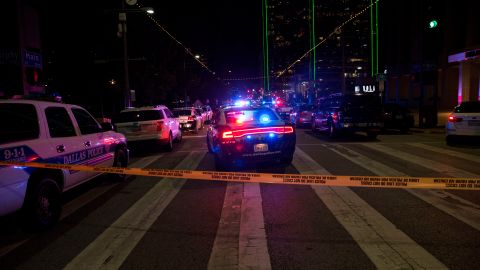 TOPSHOT - Police cars sit on Main Street in Dallas following the sniper shooting during a protest on July 7, 2016. - A fourth police officer was killed and two suspected snipers were in custody after a protest late Thursday against police brutality in Dallas, authorities said. One suspect had turned himself in and another who was in a shootout with SWAT officers was also in custody, the Dallas Police Department tweeted. (Photo by Laura Buckman / AFP) (Photo by LAURA BUCKMAN/AFP via Getty Images)