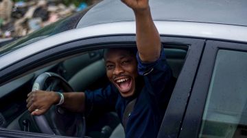 Foto de un hombre celebrando mientras conduce
