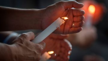 TOPSHOT - People light candles during a prayer and candle vigil organized by the city, after the shooting that left 20 people dead at the Cielo Vista Mall WalMart in El Paso, Texas, on August 4, 2019. - The United States mourned Sunday for victims of two mass shootings that killed 29 people in less than 24 hours as debate raged over whether President Donald Trump's rhetoric was partly to blame for surging gun violence. The rampages turned innocent snippets of everyday life into nightmares of bloodshed: 20 people were shot dead while shopping at a crowded Walmart in El Paso, Texas on Saturday morning, and nine more outside a bar in a popular nightlife district in Dayton, Ohio just 13 hours later. (Photo by Mark RALSTON / AFP) (Photo by MARK RALSTON/AFP via Getty Images)
