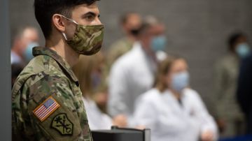 A member of the National Guard attends a press conference at a temporary field hospital at the Walter E. Convention Center in Washington, DC on May 11, 2020, featuring 437 beds for patients suffering from coronavirus, COVID-19, and part of the city's medical surge response plan as an alternate care site to assist hospitals. (Photo by SAUL LOEB / AFP) (Photo by SAUL LOEB/AFP via Getty Images)