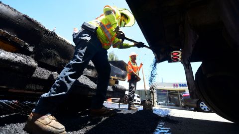 A roadworks crew work on road resurfacing on June 24, 2021 in Alhambra, California. - US President Joe Biden on Thursday announced that a deal has been reached with a bipartisan group of senators to rebuild the nation's infrastructure, likely unlocking the most funding for roads, bridges, ports and broadband in decades. (Photo by Frederic J. BROWN / AFP) (Photo by FREDERIC J. BROWN/AFP via Getty Images)