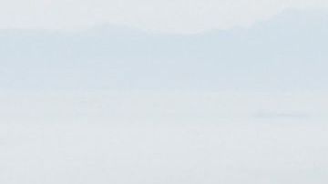 An oil platform (L) and cargo container ship (R) offshore along the coastline are seen from a US Coast Guard HC-27J Spartan aircraft during a media flight after an oil spill in the Pacific Ocean in Orange County, California on October 6, 2021. - The US Coast Guard is investigating a possible anchor strike as the cause of a broken pipeline that has spewed tens of thousands of gallons of crude oil into the sea off California, media reported on October 5. (Photo by Patrick T. FALLON / AFP) (Photo by PATRICK T. FALLON/AFP via Getty Images)