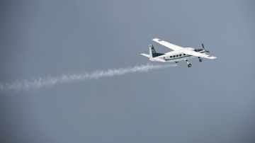 This picture taken on March 25, 2016 shows a pair of Cessna 208 Caravan aircraft from the Thai Department of Royal Rainmaking depositing a sodium chloride-based material above clouds in Nakhon Sawan in an effort to produce rain. Thailand's prime minister last week told farmers to cultivate less rice to help the country manage its intensifying water crisis, as experts called this year's drought the worst in decades. Water reserves across the country have dipped below last year's levels, which were already considered a record low, according to the irrigation department. / AFP / LILLIAN SUWANRUMPHA (Photo credit should read LILLIAN SUWANRUMPHA/AFP via Getty Images)